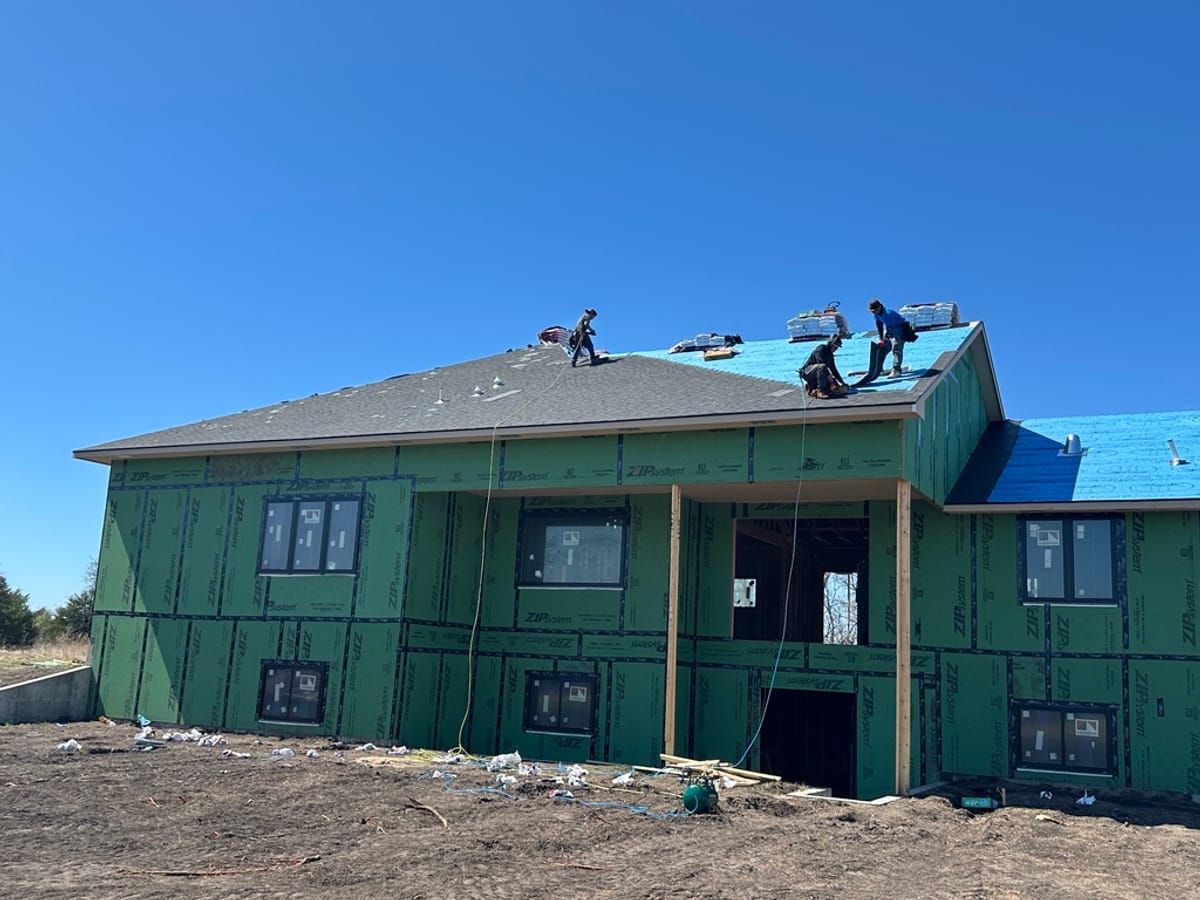 A JAKS crew shingling a residential roof on a new build in the Wichita area