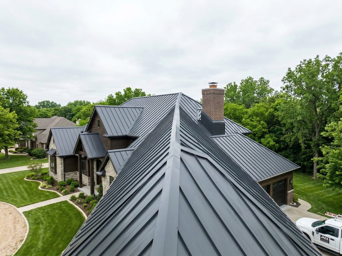 Newly installed charcoal standing seam metal roof on a large Wichita area home