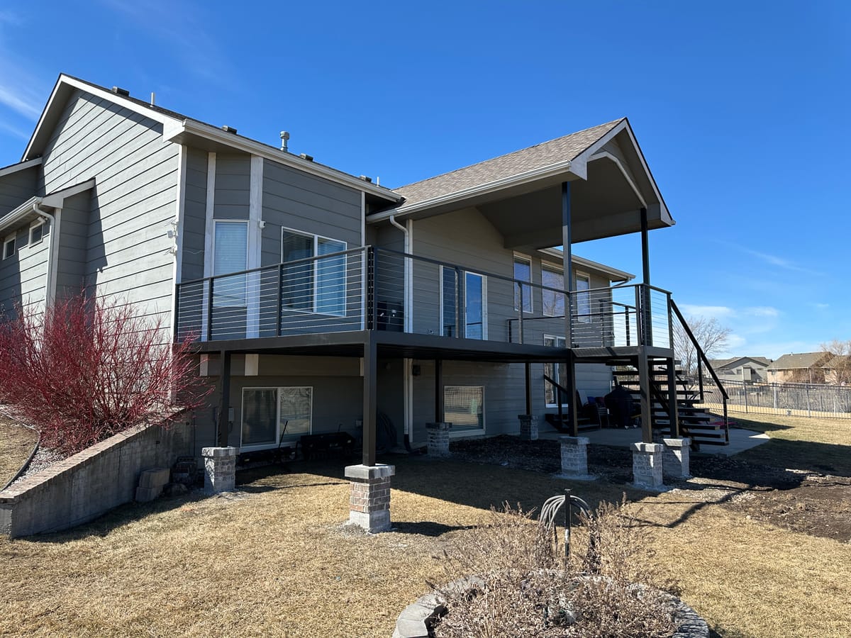 A finished deck and covered porch built by JAKS Construction